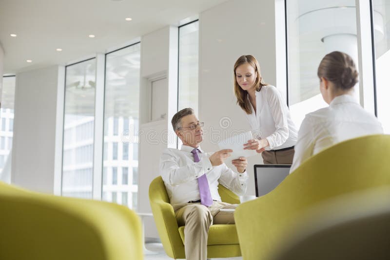 Business people working in office lobby. Business people working in office lobby