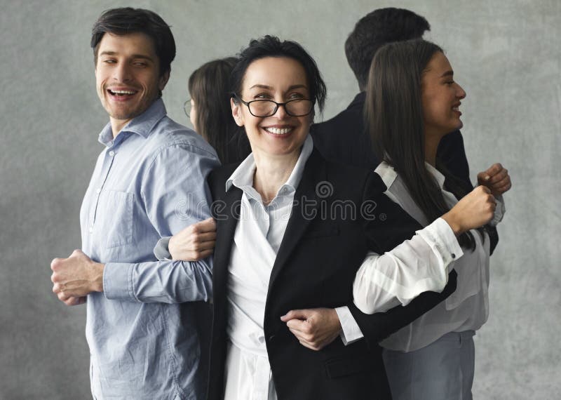 Teambuilding concept. Business team standing in vicious circle and smiling. Teambuilding concept. Business team standing in vicious circle and smiling