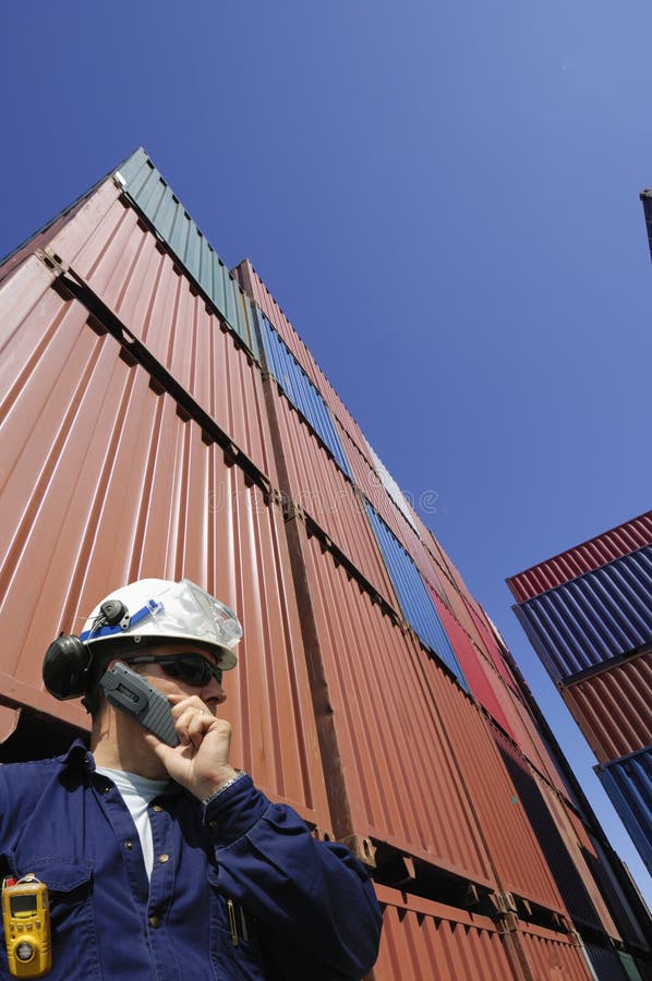 Port and dock worker with stacks of cargo containers in background. Port and dock worker with stacks of cargo containers in background