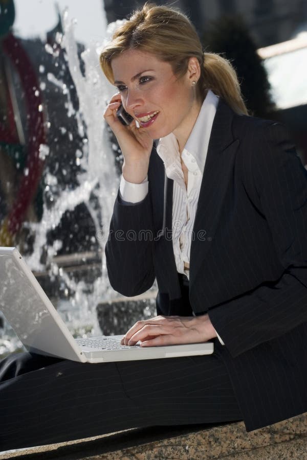 Girl sitting alone on a wall and working with her laptop. Girl sitting alone on a wall and working with her laptop