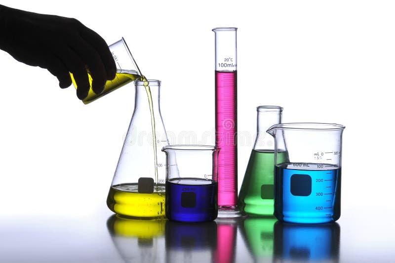 Laboratory Glassware containing different colored liquids against a neutral background. Laboratory Glassware containing different colored liquids against a neutral background