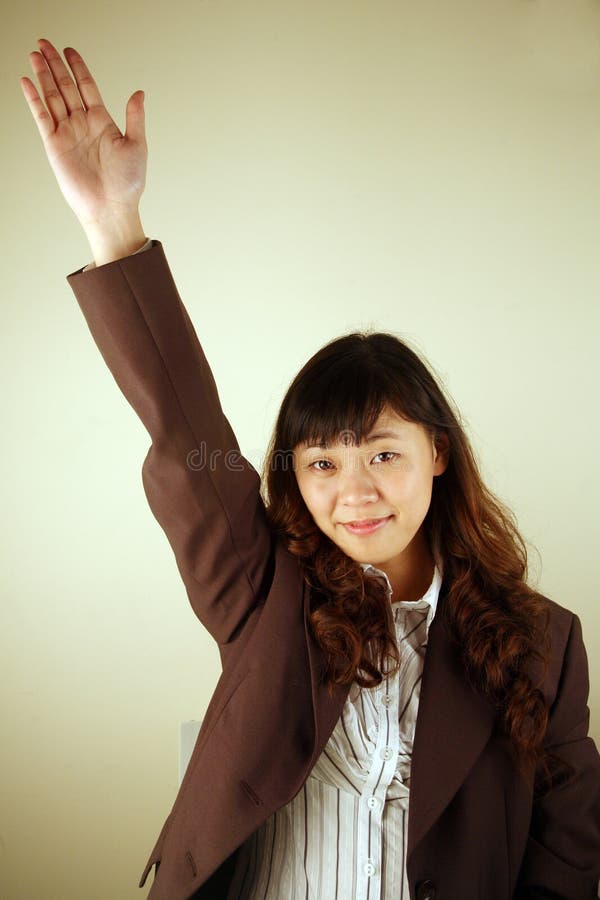 Businesswoman raising her hand with a question. Businesswoman raising her hand with a question