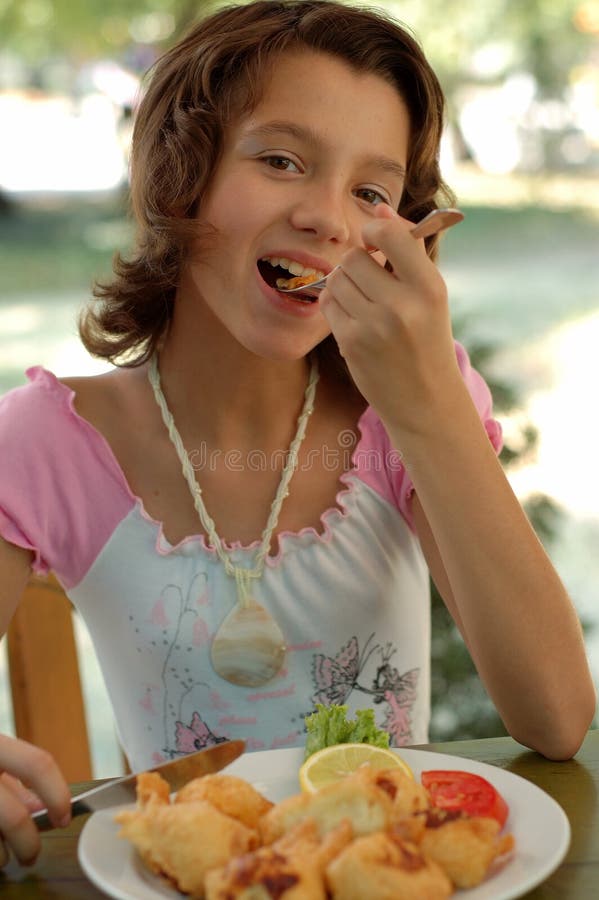 Young Girl Enjoying a cheese at a restaurant. Young Girl Enjoying a cheese at a restaurant