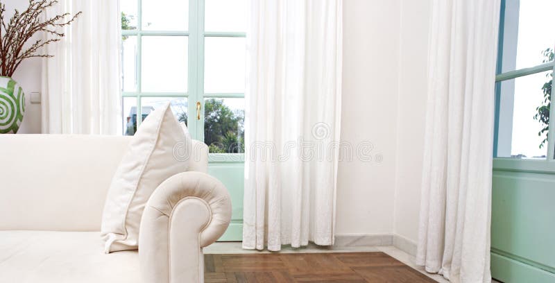 Stylish home living room with white sofa and glass doors. Stylish home living room with white sofa and glass doors.