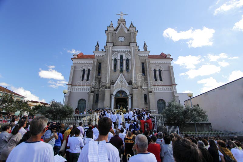 OLIVEIRA, MG / BRAZIL - 2015-06-04: Catholic celebrant blesses faithful in front of church ending Corpus Christi procession. OLIVEIRA, MG / BRAZIL - 2015-06-04: Catholic celebrant blesses faithful in front of church ending Corpus Christi procession