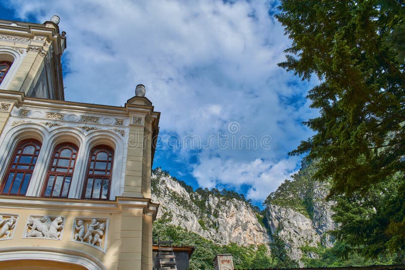 Wide angle view of Baile Herculane Casino with blue sky in background and an old tree outdoor day summer. Wide angle view of Baile Herculane Casino with blue sky in background and an old tree outdoor day summer