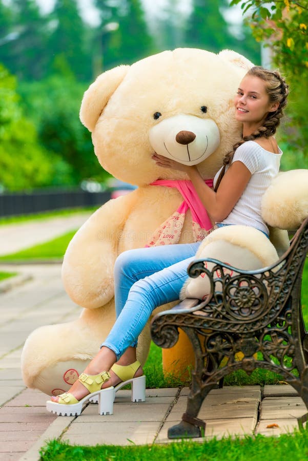 ευτυχές όμορφο κορίτσι σε έναν πάγκο με μια teddy αρκούδα στοκ φωτογραφία με δικαίωμα ελεύθερης χρήσης ευτυχές όμορφο κορίτσι σε έναν πάγκο με μια teddy αρκούδα στοκ φωτογραφία με δικαίωμα ελεύθερης χρήσης
