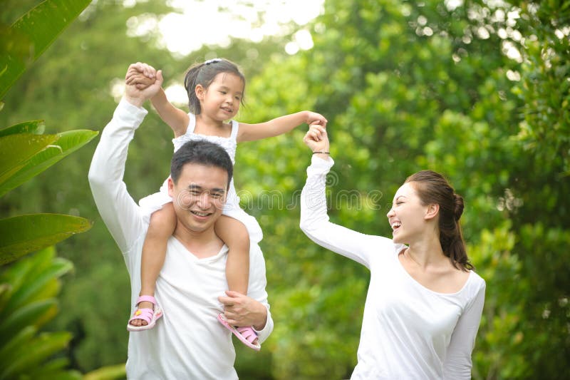 Happy Asian Family enjoying family time together in the park. Happy Asian Family enjoying family time together in the park