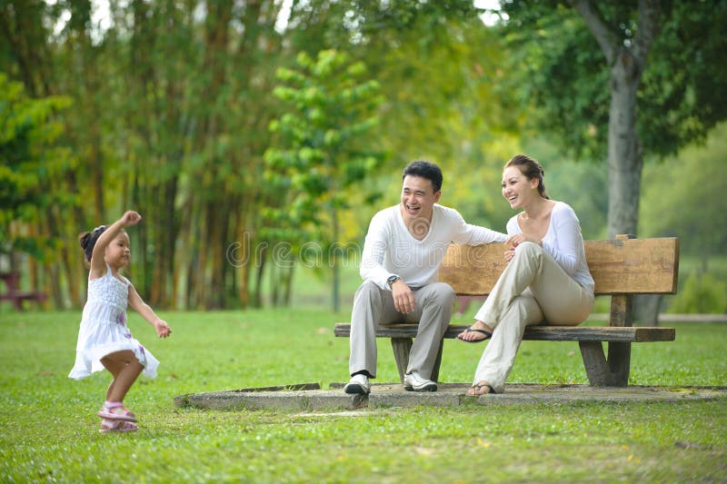 Happy Asian Family enjoying their time in the park. Happy Asian Family enjoying their time in the park