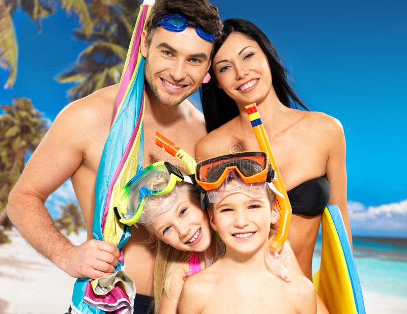 Portrait of happy fun beautiful family with two children at tropical beach with protective swimming mask. Portrait of happy fun beautiful family with two children at tropical beach with protective swimming mask