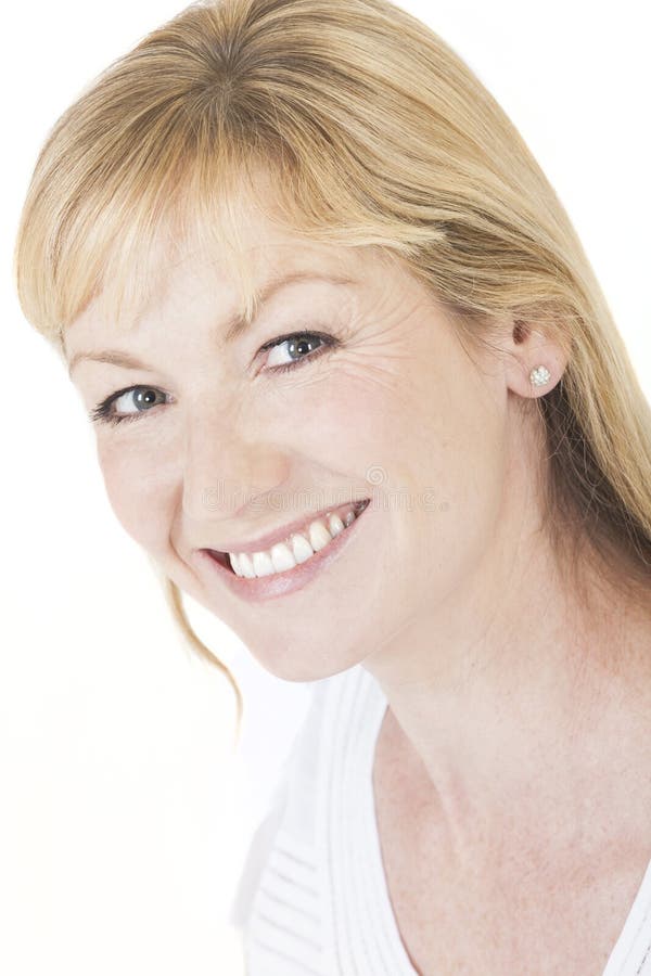 Studio portrait head shot of a happy smiling attractive middle aged blonde woman with perfect teeth. Studio portrait head shot of a happy smiling attractive middle aged blonde woman with perfect teeth