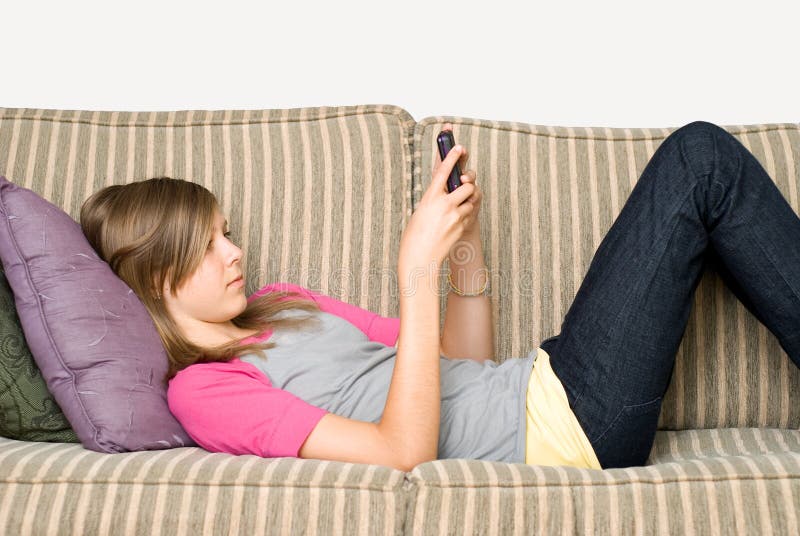 Teen or pre teen girl texting on her cell phone. Teen or pre teen girl texting on her cell phone