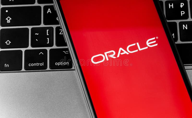 Oracle logo app on the red screen smartphone with notebook closeup. Oracle is an American multinational computer technology corporation. Moscow, Russia - September 25, 2020. Oracle logo app on the red screen smartphone with notebook closeup. Oracle is an American multinational computer technology corporation. Moscow, Russia - September 25, 2020