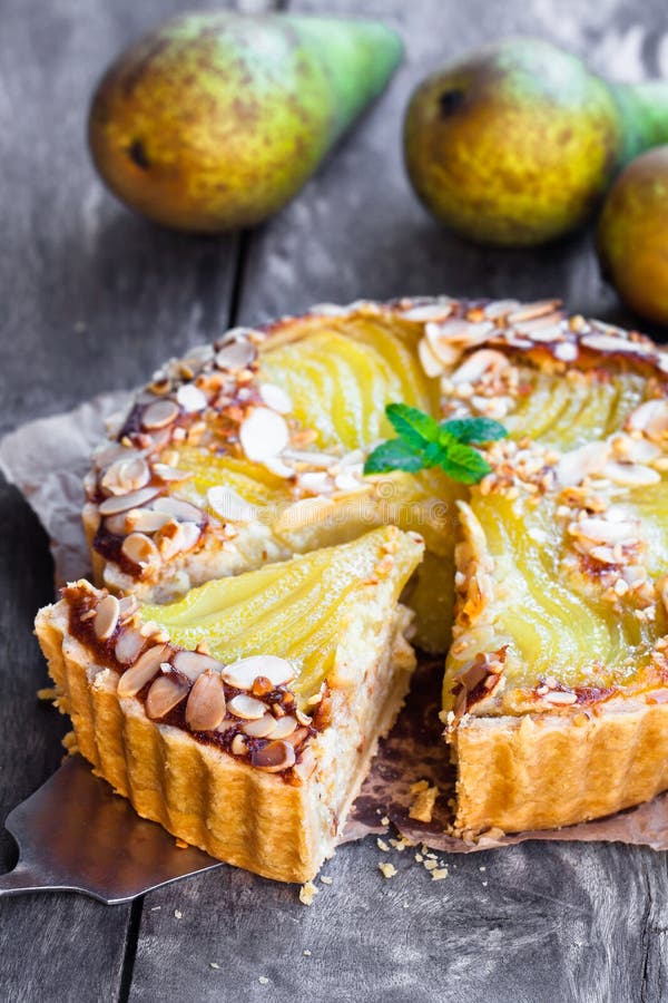 Delicious cake with half poached pears and almond flakes. Delicious cake with half poached pears and almond flakes