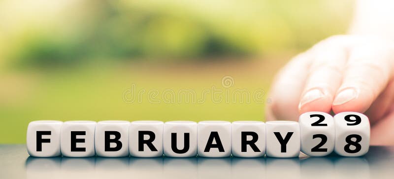 Hand turns dice and changes the date from `February 28` to `February 29. Hand turns dice and changes the date from `February 28` to `February 29
