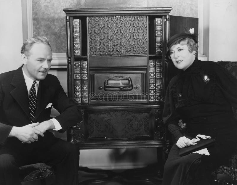 Couple listening to radio (All persons depicted are no longer living and no estate exists. Supplier grants that there will be no model release issues.). Couple listening to radio (All persons depicted are no longer living and no estate exists. Supplier grants that there will be no model release issues.)