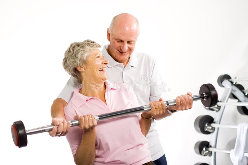 Older mature couple lifting weights in the gym. Older mature couple lifting weights in the gym