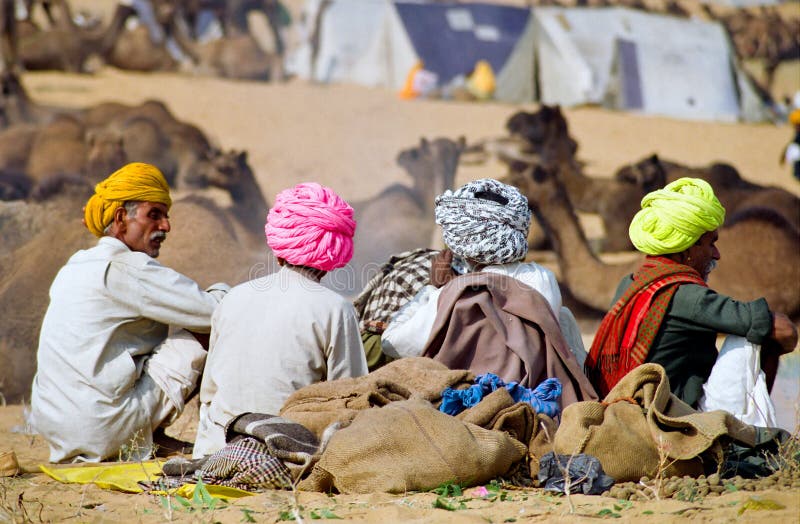 4 camel traders having a coffee break while displaying an aesthetic and colorful set of turbans, Pushkar, India. 4 camel traders having a coffee break while displaying an aesthetic and colorful set of turbans, Pushkar, India