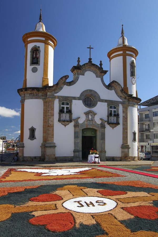 OLIVEIRA, MG / BRAZIL - 2015-06-04: Colorful carpets adorn the front of the baroque church for the celebration of Corpus Christ in Minas Gerais. OLIVEIRA, MG / BRAZIL - 2015-06-04: Colorful carpets adorn the front of the baroque church for the celebration of Corpus Christ in Minas Gerais.