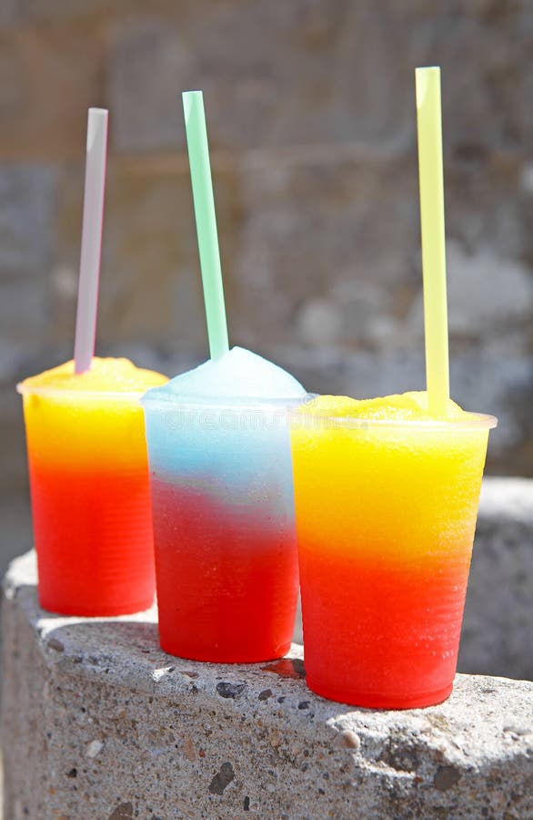 Colorful slushy ice drinks in plastic cups. Colorful slushy ice drinks in plastic cups
