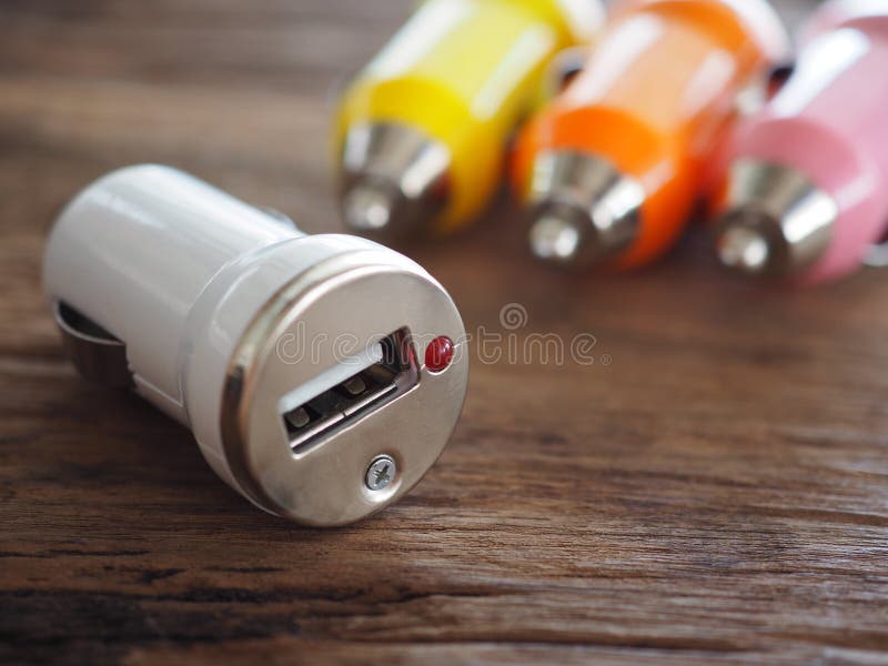 Ζωηρόχρωμος φορτιστής αυτοκινήτων USB σε έναν ξύλινο πίνακα με την έννοια τεχνολογίας και ενέργειας στοκ εικόνα Ζωηρόχρωμος φορτιστής αυτοκινήτων USB σε έναν ξύλινο πίνακα με την έννοια τεχνολογίας και ενέργειας στοκ εικόνα