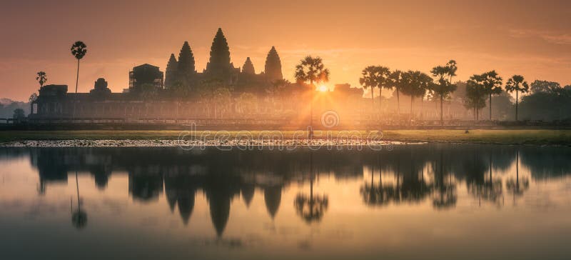Sunrise view of popular tourist attraction ancient temple complex Angkor Wat with reflected in lake Siem Reap, Cambodia. Clipping path of sky. Sunrise view of popular tourist attraction ancient temple complex Angkor Wat with reflected in lake Siem Reap, Cambodia. Clipping path of sky