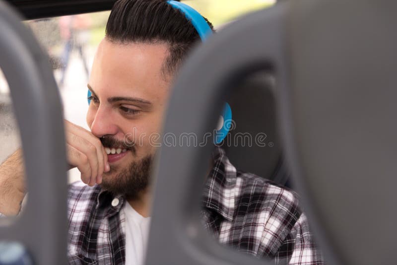 Η έννοια ανταλάσσει, φιλοδοξίες, ταξίδι Ευτυχής ταξιδιώτης που φορά το πουκάμισο καρό που ακούει τη μουσική στο λεωφορείο πόλεων στοκ φωτογραφίες με δικαίωμα ελεύθερης χρήσης Η έννοια ανταλάσσει, φιλοδοξίες, ταξίδι Ευτυχής ταξιδιώτης που φορά το πουκάμισο καρό που ακούει τη μουσική στο λεωφορείο πόλεων στοκ φωτογραφίες με δικαίωμα ελεύθερης χρήσης