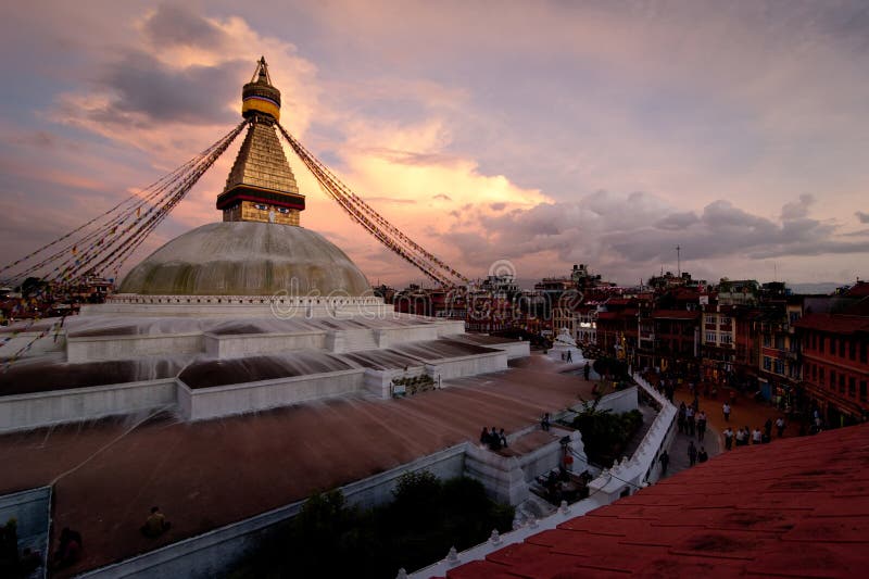 Buddhist Shrine Boudhanath Stupa with pray flags over sunset sky. Nepal, Kathmandu. Buddhist Shrine Boudhanath Stupa with pray flags over sunset sky. Nepal, Kathmandu