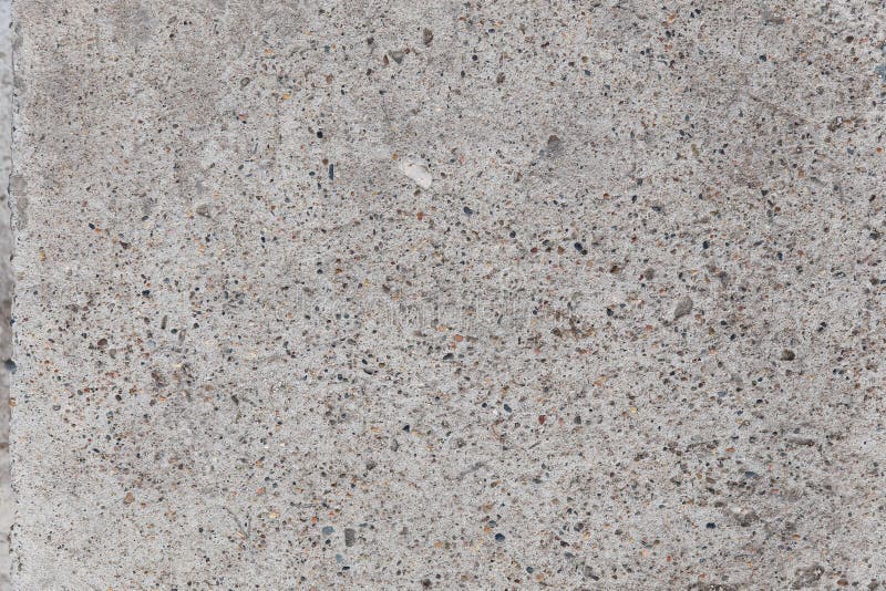 The gray texture of the concrete. Lines, points, pebbles, and holes in the concrete. Abstract grey grunge background. The gray texture of the concrete. Lines, points, pebbles, and holes in the concrete. Abstract grey grunge background.