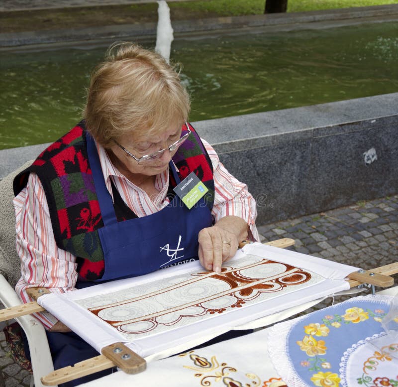 The elderly woman is embroidering during Festival Craftsmen Days ULUV in summer 2013 in Bratislava, Slovakia. Festival as a part of The Summer of Culture festival Bratislava, Slovakia, was held from August 31 to September 1, 2013, in the pedestrian zone of the Capital. There are over 100 craftsmen expected to attend and perform their skills in crafts. The elderly woman is embroidering during Festival Craftsmen Days ULUV in summer 2013 in Bratislava, Slovakia. Festival as a part of The Summer of Culture festival Bratislava, Slovakia, was held from August 31 to September 1, 2013, in the pedestrian zone of the Capital. There are over 100 craftsmen expected to attend and perform their skills in crafts.