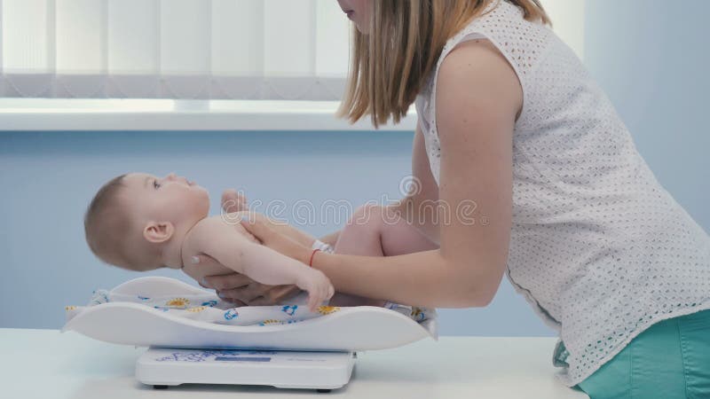 Η μητέρα έβαλε το γιο weigher για να μετρήσει το βάρος