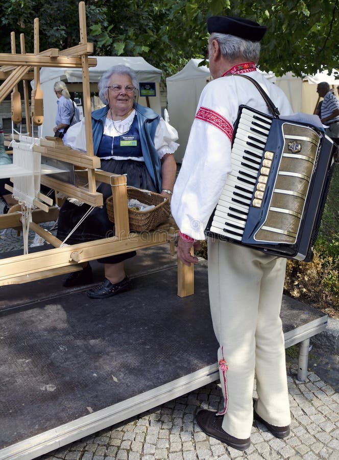 The elderly women is spinning and weaving during Festival Craftsmen Days ULUV in summer 2013 in Bratislava, Slovakia. Festival as a part of The Summer of Culture festival Bratislava, Slovakia, was held from August 31 to September 1, 2013, in the pedestrian zone of the Capital. There are over 100 craftsmen expected to attend and perform their skills in crafts. The elderly women is spinning and weaving during Festival Craftsmen Days ULUV in summer 2013 in Bratislava, Slovakia. Festival as a part of The Summer of Culture festival Bratislava, Slovakia, was held from August 31 to September 1, 2013, in the pedestrian zone of the Capital. There are over 100 craftsmen expected to attend and perform their skills in crafts.