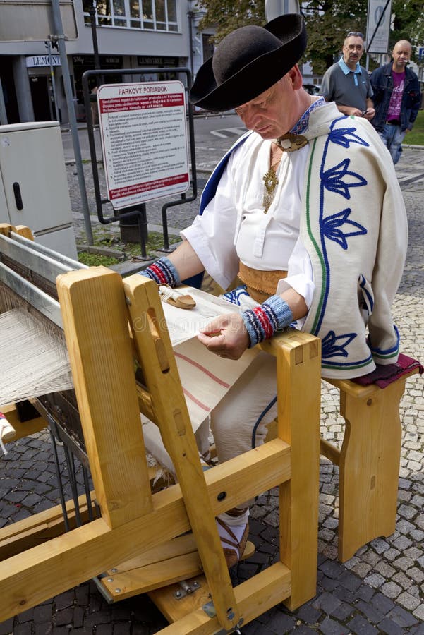 The man in traditional outfit is spining and weaving during Festival Craftsmen Days ULUV in summer 2013 in Bratislava, Slovakia. Festival as a part of The Summer of Culture festival Bratislava, Slovakia, was held from August 31 to September 1, 2013, in the pedestrian zone of the Capital. There are over 100 craftsmen expected to attend and perform their skills in crafts. The man in traditional outfit is spining and weaving during Festival Craftsmen Days ULUV in summer 2013 in Bratislava, Slovakia. Festival as a part of The Summer of Culture festival Bratislava, Slovakia, was held from August 31 to September 1, 2013, in the pedestrian zone of the Capital. There are over 100 craftsmen expected to attend and perform their skills in crafts.