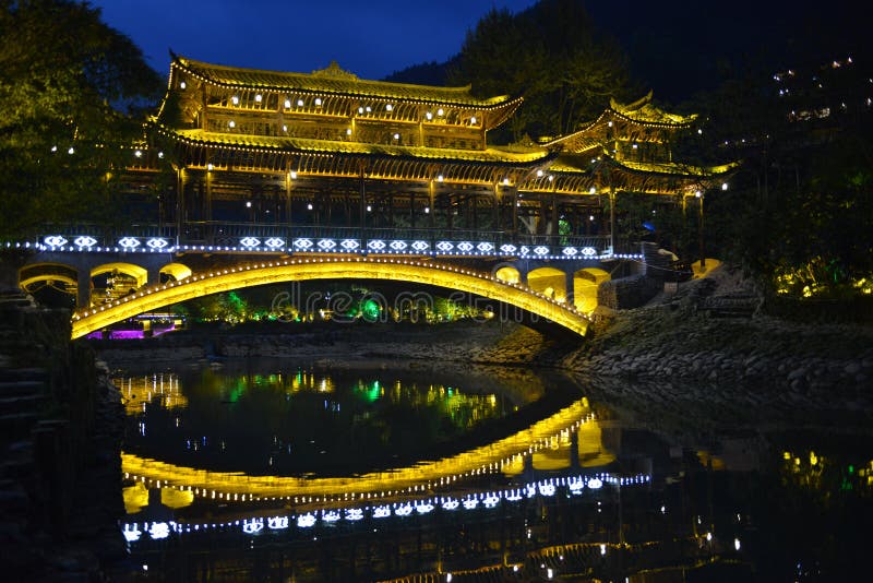 Located on the north side of Leigong Hill, Xijiang Qianhu Miao Village is about 35 km 22 miles away from Kaili city; the capital of Qiandongnan, and about 260 km 162 miles from Guiyang City; the capital city of Guizhou Province. Being the largest gathering place of the Miao in China and even the world, about ten natural Miao ethnic villages exist in Xijiang Town and the Miao culture is best preserved in this area. According to the latest statistics, there are about 1,288 families with a total population of around 6,000 people living there. 99.5% of the local people are Miao nationality. Fengyu bridge Wind-rain bridge plays an important role there. It is built by Miao people in the purpose of improving living conditions and protecting local environment. There are five Fengyu bridges made of the mixed construction of cement and wood. These bridges can connect the banks of the river and withstand flood. Located on the north side of Leigong Hill, Xijiang Qianhu Miao Village is about 35 km 22 miles away from Kaili city; the capital of Qiandongnan, and about 260 km 162 miles from Guiyang City; the capital city of Guizhou Province. Being the largest gathering place of the Miao in China and even the world, about ten natural Miao ethnic villages exist in Xijiang Town and the Miao culture is best preserved in this area. According to the latest statistics, there are about 1,288 families with a total population of around 6,000 people living there. 99.5% of the local people are Miao nationality. Fengyu bridge Wind-rain bridge plays an important role there. It is built by Miao people in the purpose of improving living conditions and protecting local environment. There are five Fengyu bridges made of the mixed construction of cement and wood. These bridges can connect the banks of the river and withstand flood.