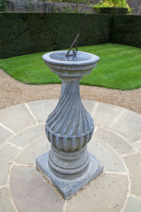 A sundial in the formal gardens at Wakehurst Place in Sussex, England. A sundial in the formal gardens at Wakehurst Place in Sussex, England.
