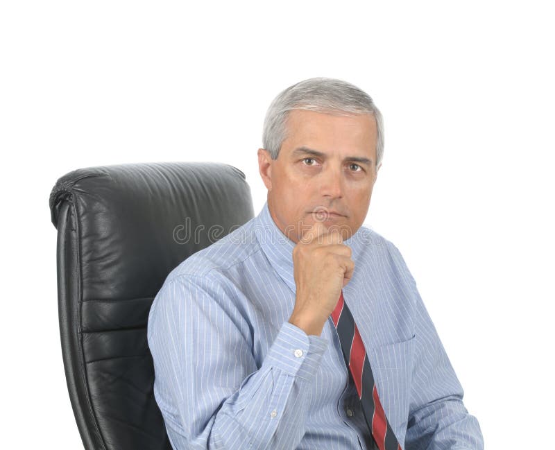 Portrait of a Serious Middle Aged Businessman sitting in office chair with hand on chin isolated over white. Portrait of a Serious Middle Aged Businessman sitting in office chair with hand on chin isolated over white