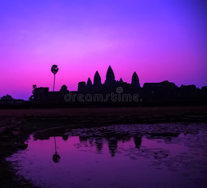 Beautiful Purple dramatic sky colorful sunrise at lake holy Angkor Wat facade silhouette, famous destination in Cambodia. Angkor Archaeological Park near Siem Reap in Cambodia. Beautiful Purple dramatic sky colorful sunrise at lake holy Angkor Wat facade silhouette, famous destination in Cambodia. Angkor Archaeological Park near Siem Reap in Cambodia.