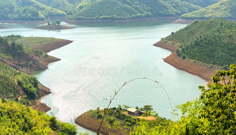 Sunny afternoon on the hillside hydrogen lake Ta Dung. There are large reservoirs providing water for large areas in the highlands of Vietnam. Sunny afternoon on the hillside hydrogen lake Ta Dung. There are large reservoirs providing water for large areas in the highlands of Vietnam