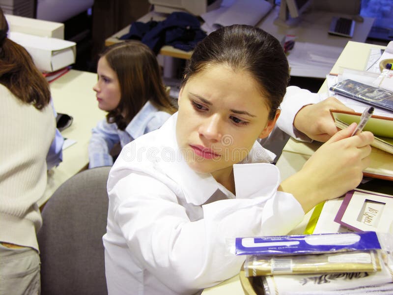 Young woman at work, looking busy and preoccupied. Can fit many concepts depicting business stress and job issues. Young woman at work, looking busy and preoccupied. Can fit many concepts depicting business stress and job issues.