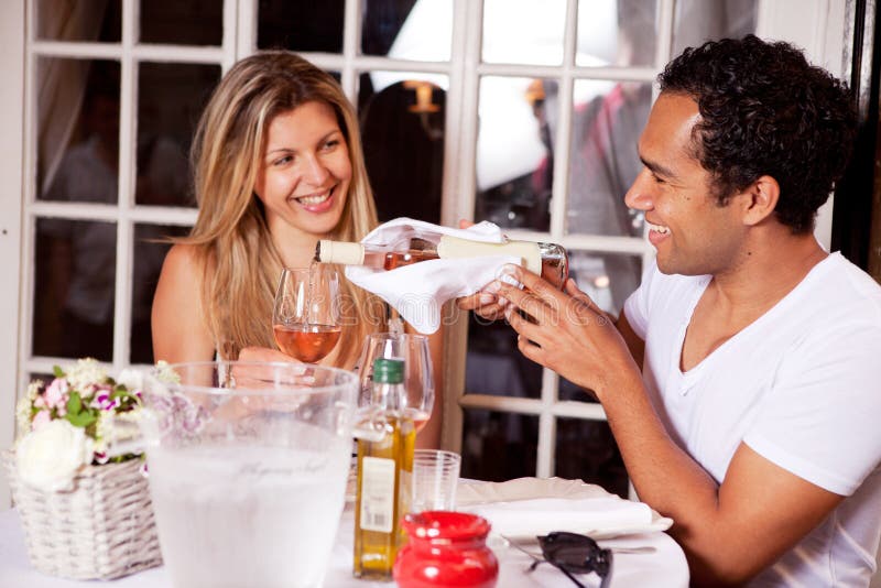 A happy couple on a date to an outdoor cafe; shallow DOF with focus on male. A happy couple on a date to an outdoor cafe; shallow DOF with focus on male