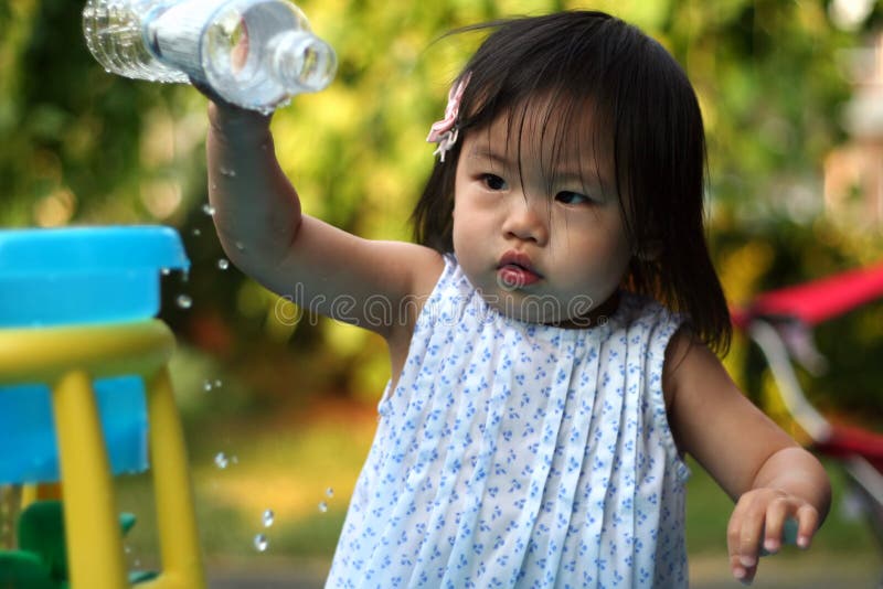 Toddler playing with her water table in the heat of the summer. Toddler playing with her water table in the heat of the summer