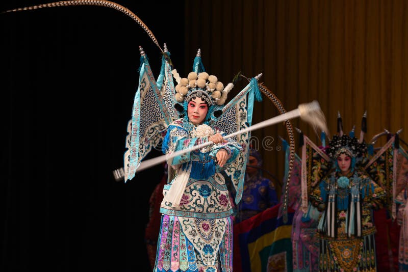 This opera tells a patriotic story how does an old woman of a hundred years old go out for a battle with the twelve women generals of Yang family herself. During the period of Renzong in Song Dynasty, the king of Western Xia invaded its border region, the Song Dynasty’s supreme commander Yang Zongbao fought against the enemies bravely with his army, but unfortunately, he died in the battle by an arrow shot from hiding. Meanwhile, She Taijun of one hundred years old in Yang family was giving a banquet to celebrate her grandson Zongbao’s fiftieth birthday. Everyone in the family was grieved deeply when the tragic news came. When She Taijun heard that the royal court was going to cede territories for peace, she suppressed her grief, refuted the fallacy sternly, and decided to go for the battle herself with the women generals of the Yang family. The great-grandson Yang Wenguang wanted to go with them, his grandmother Princess Chai didn’t let him go in consideration of perpetuating the Yang line. She Taijun told him that he could challenge martial art skills with his mother Mu Guiying to prove whether he can go or not. With his mother’s pretending to fail by his spear skill and the help of Du Jine, the wife of Yang Yansi, Yang Wenguang got his wish. After being defeated utterly, the king of Western Xia intended to capture Yang The Beijing Opera Women Generals of Yang Family was performed in Jiangxi Art Center by The Beijing Opera Troupe of Fujian Province. This opera tells a patriotic story how does an old woman of a hundred years old go out for a battle with the twelve women generals of Yang family herself. During the period of Renzong in Song Dynasty, the king of Western Xia invaded its border region, the Song Dynasty’s supreme commander Yang Zongbao fought against the enemies bravely with his army, but unfortunately, he died in the battle by an arrow shot from hiding. Meanwhile, She Taijun of one hundred years old in Yang family was giving a banquet to celebrate her grandson Zongbao’s fiftieth birthday. Everyone in the family was grieved deeply when the tragic news came. When She Taijun heard that the royal court was going to cede territories for peace, she suppressed her grief, refuted the fallacy sternly, and decided to go for the battle herself with the women generals of the Yang family. The great-grandson Yang Wenguang wanted to go with them, his grandmother Princess Chai didn’t let him go in consideration of perpetuating the Yang line. She Taijun told him that he could challenge martial art skills with his mother Mu Guiying to prove whether he can go or not. With his mother’s pretending to fail by his spear skill and the help of Du Jine, the wife of Yang Yansi, Yang Wenguang got his wish. After being defeated utterly, the king of Western Xia intended to capture Yang The Beijing Opera Women Generals of Yang Family was performed in Jiangxi Art Center by The Beijing Opera Troupe of Fujian Province.