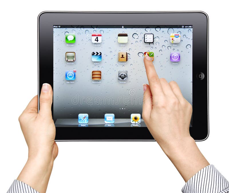 Kiev, Ukraine - April 03, 2012: Female hands holding Apple iPad (32Gb, wi-fi) with homepage on a screen. This second generation Ipad is designed and development by Apple inc. Kiev, Ukraine - April 03, 2012: Female hands holding Apple iPad (32Gb, wi-fi) with homepage on a screen. This second generation Ipad is designed and development by Apple inc.