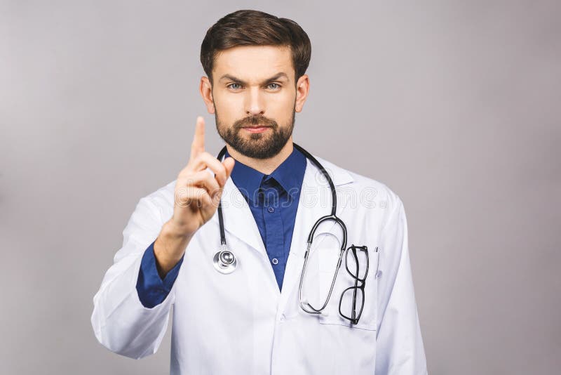 Angry male doctor pointing finger at you with stethoscope around his neck, pointing at camera with serious face isolated on grey background. Angry male doctor pointing finger at you with stethoscope around his neck, pointing at camera with serious face isolated on grey background