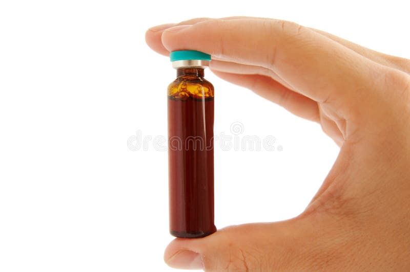 hand holding a small medicine bottle. Isolated on a white background. hand holding a small medicine bottle. Isolated on a white background.