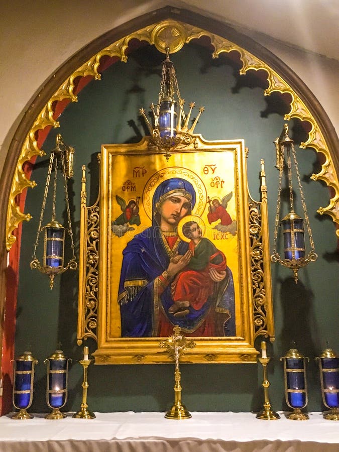 The original painting of Our Lady of Perpetual Help A.K.A. Mother of Perpetual Help and Our Lady of Perpetual Succour was created by an anonymous artist possibly a monk who lived in Crete in the style of the Virgin of the Passion which represents the Christian mystery of Redemption. Since 1499, the image is in Rome and permanently enshrined in the church of Sant`Alfonso di Liguori, where the official Novena to Our Mother of Perpetual Help text is prayed weekly. In June 23, 1867, the image was granted a Canonical Coronation and its official recognition of the Marian icon under its present title.
 
In 1931, a replica painting from St. Patrick`s Cathedral, New York, was sent to the Parish Church of The Holy Innocents to honor the inauguration of the Shrine of Our Lady of Perpetual.

Four Icon Symbols
The painting of the Mother of God, Jesus Christ, and the Archangels Michael and Gabriel are identified by the Greek letters.

1. MP-OY [theta O]: represents Mother of God, on the two sides of the upper part of the icon
2. IC-XC: represents Jesus Christ, on the right side

3. OPM: represents Archangel Michael, on the left side above the Angel

4. OPT [tau]: represents Archangel Gabriel, on the right side above the Angel

Our Lady of Perpetual draws us to pray, it is the mysteries of Salvation. Many like to say the Rosary before this iconic painting. The original painting of Our Lady of Perpetual Help A.K.A. Mother of Perpetual Help and Our Lady of Perpetual Succour was created by an anonymous artist possibly a monk who lived in Crete in the style of the Virgin of the Passion which represents the Christian mystery of Redemption. Since 1499, the image is in Rome and permanently enshrined in the church of Sant`Alfonso di Liguori, where the official Novena to Our Mother of Perpetual Help text is prayed weekly. In June 23, 1867, the image was granted a Canonical Coronation and its official recognition of the Marian icon under its present title.
 
In 1931, a replica painting from St. Patrick`s Cathedral, New York, was sent to the Parish Church of The Holy Innocents to honor the inauguration of the Shrine of Our Lady of Perpetual.

Four Icon Symbols
The painting of the Mother of God, Jesus Christ, and the Archangels Michael and Gabriel are identified by the Greek letters.

1. MP-OY [theta O]: represents Mother of God, on the two sides of the upper part of the icon
2. IC-XC: represents Jesus Christ, on the right side

3. OPM: represents Archangel Michael, on the left side above the Angel

4. OPT [tau]: represents Archangel Gabriel, on the right side above the Angel

Our Lady of Perpetual draws us to pray, it is the mysteries of Salvation. Many like to say the Rosary before this iconic painting.