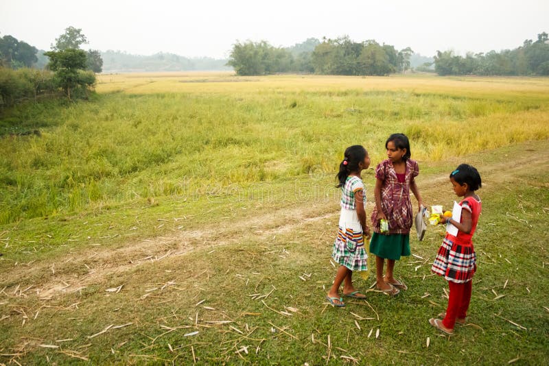 Children, young girls in a rural Indian background. Fields in the background with villager children talking. Children, young girls in a rural Indian background. Fields in the background with villager children talking.