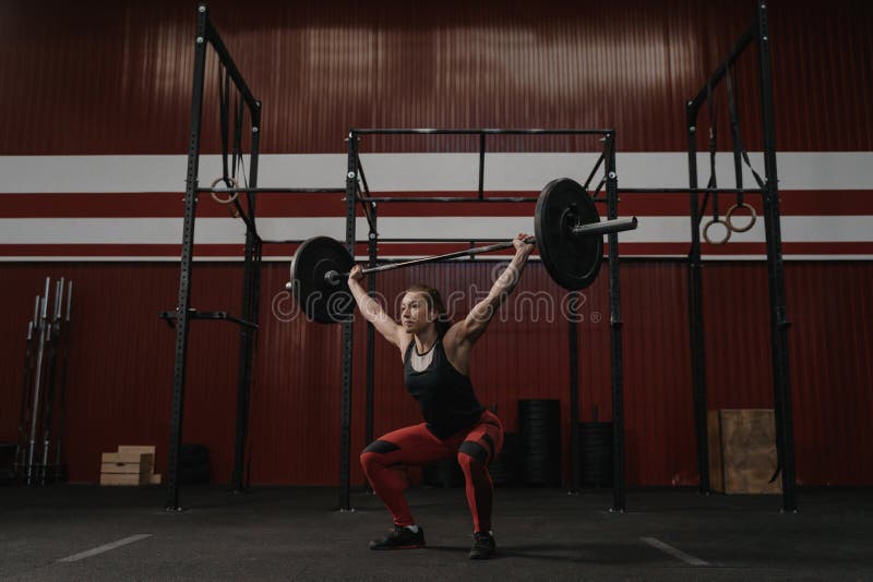 Ισχυρή ανύψωση γυναικών barbell υπερυψωμένη, κάνοντας crossfit τις ασκήσεις στοκ εικόνα με δικαίωμα ελεύθερης χρήσης Ισχυρή ανύψωση γυναικών barbell υπερυψωμένη, κάνοντας crossfit τις ασκήσεις στοκ εικόνα με δικαίωμα ελεύθερης χρήσης