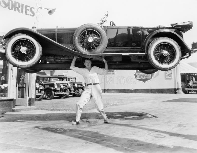 Strong man lifting a car over his head (All persons depicted are no longer living and no estate exists. Supplier grants that there will be no model release issues.). Strong man lifting a car over his head (All persons depicted are no longer living and no estate exists. Supplier grants that there will be no model release issues.)