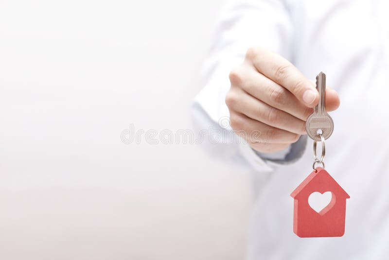 Small house key with heart in hand. Small house key with heart in hand